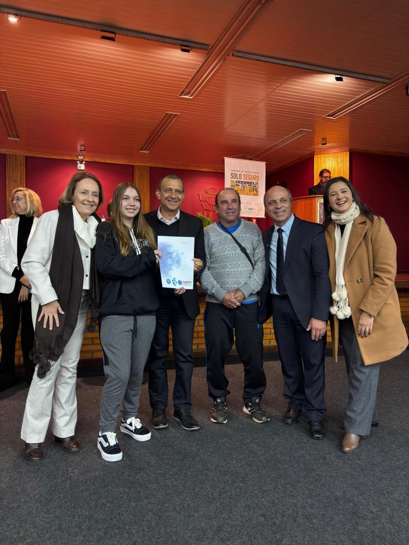 foto colorida de familia recebendo titulo